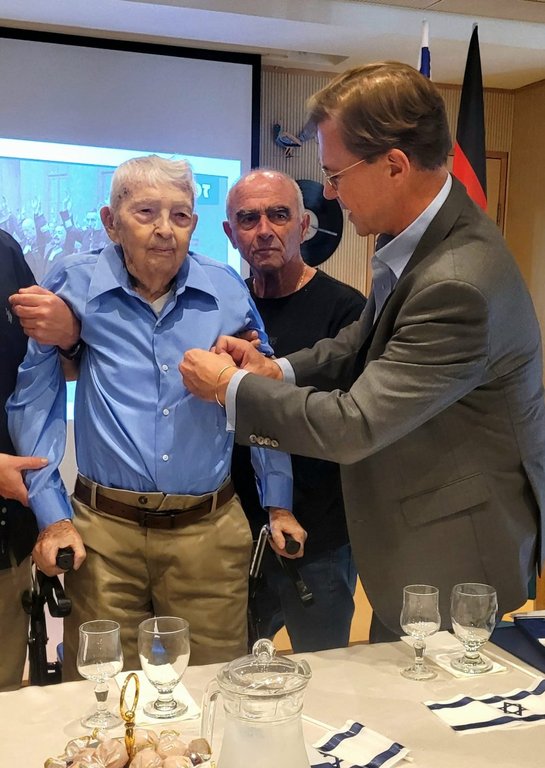 German Ambassador to Israel Steffen Seibert, right, honours late Holocaust survivor Michael Seuss, left, with the German Federal Cross of Merit at the Anita Miller-Cohen-Home for elderly in Ramat Gan, Israel, Sept. 10, 2025. (German Embassy to Israel via AP)