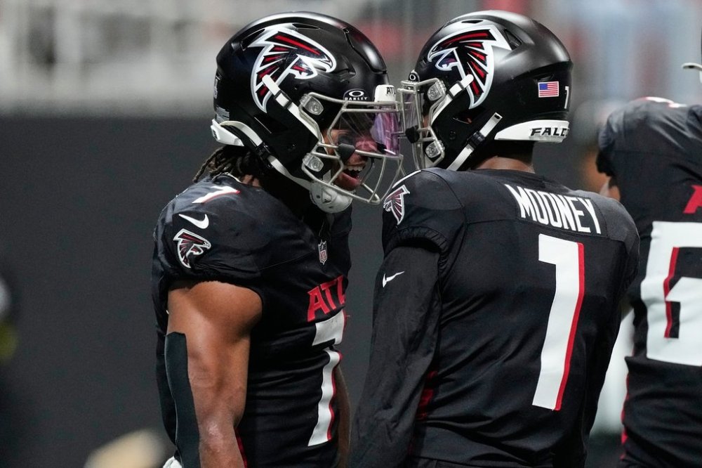 Atlanta Falcons running back Bijan Robinson, left, celebrates his touchdown against the Washington Commanders with wide receiver Darnell Mooney (1) during the first half of an NFL football game, Sunday, Sept. 28, 2025, in Atlanta. (AP Photo/Brynn Anderson)