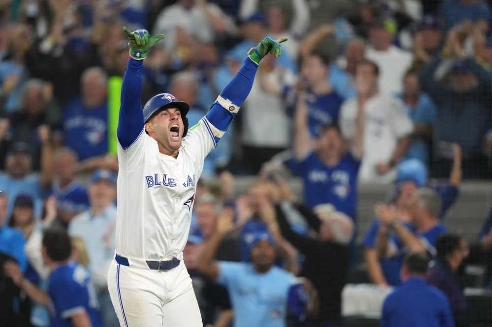 Toronto Blue Jays' George Springer reacts after hitting a three-run home run against the Seattle Mariners during the seventh inning of the MLB American League Championship Series Game 7 in Toronto, Monday, Oct. 20, 2025. THE CANADIAN PRESS/Nathan Denette