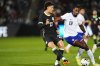 Australia defender Alessandro Circati, left, passes the ball as United States forward Haji Wright defends in the first half of an international friendly soccer match Tuesday, Oct. 14, 2025, in Commerce City, Colo. (AP Photo/David Zalubowski)