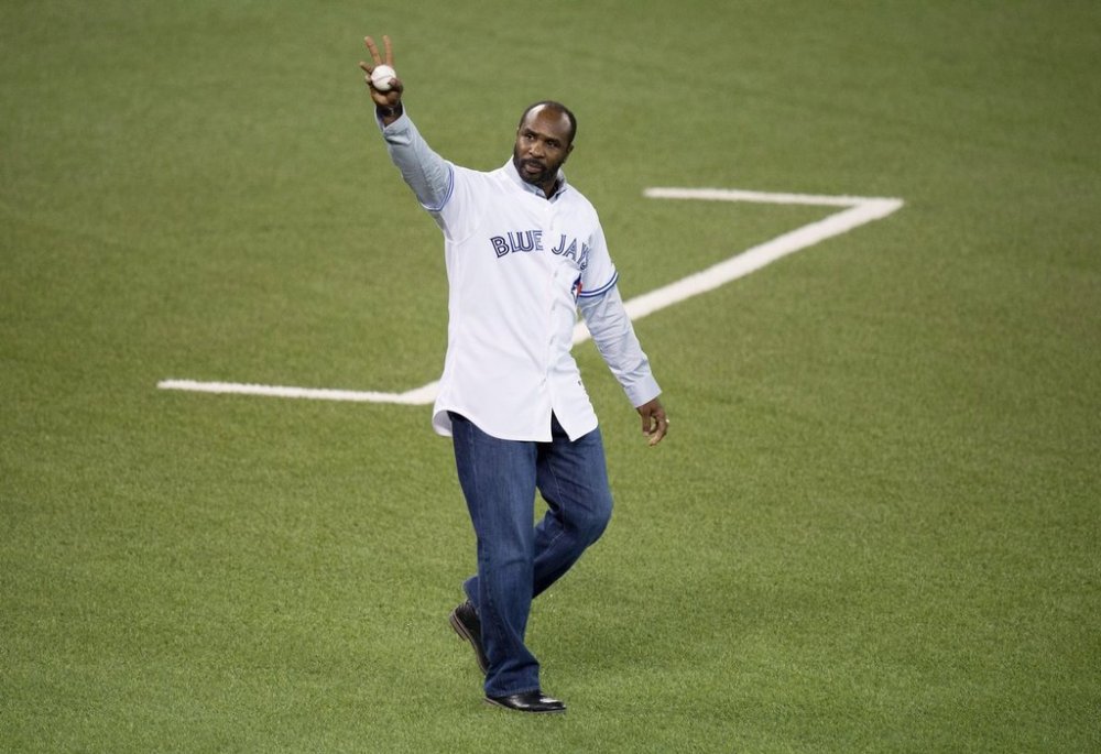 Former Toronto Blue Jays player Devon White acknowledges the fans before throwing the ceremonial first pitch at game three of the American League Championship Series between the Toronto Blue Jays and Kansas City Royals in Toronto on Monday, October 19, 2015. THE CANADIAN PRESS/Darren Calabrese