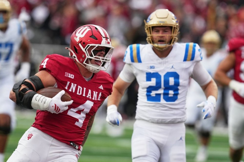 Indiana linebacker Aiden Fisher (4) runs back an interception for a touchdown during the first half of an NCAA college football game against UCLA, Saturday, Oct. 25, 2025, in Bloomington, Ind. (AP Photo/Darron Cummings)