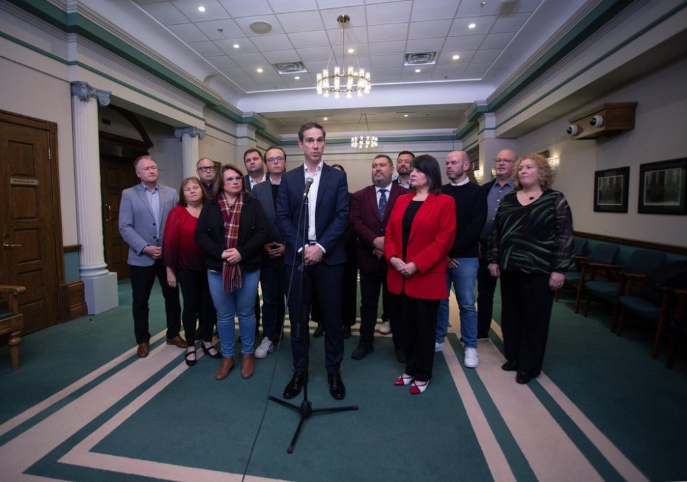 The leader of Newfoundland and Labrador's Liberals John Hogan, centre, speaks during a news conference outside the Hall of Assembly in St. John's on Tuesday, October 28, 2025.  THE CANADIAN PRESS/Paul Daly