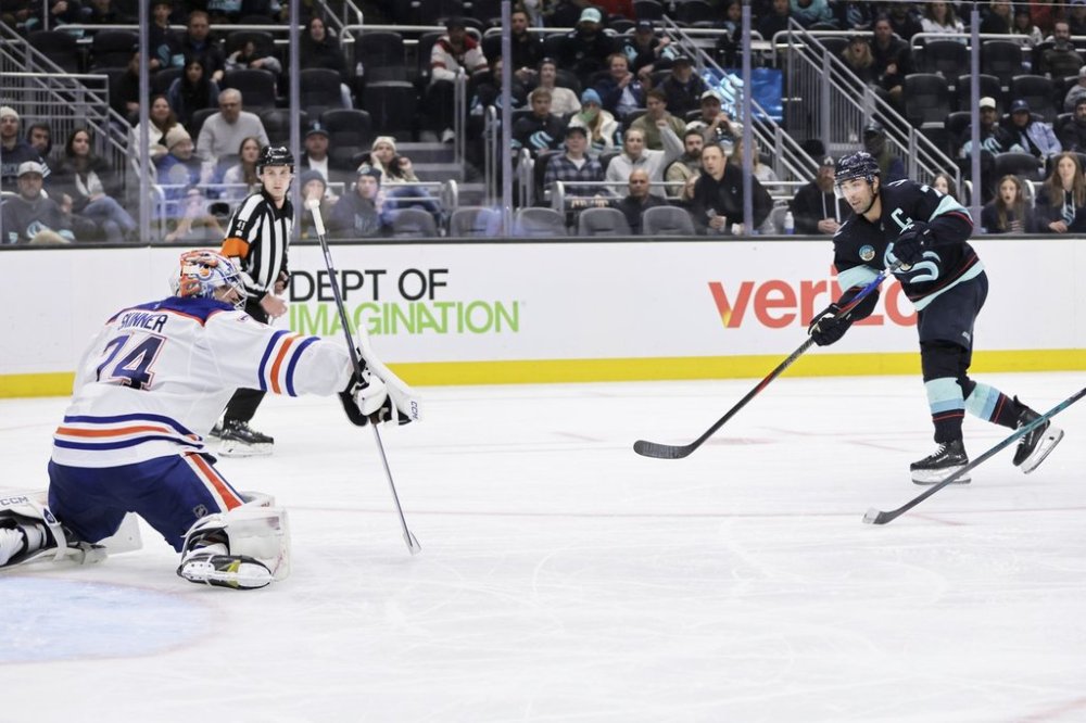 Seattle Kraken right wing Jordan Eberle (7) scores against Edmonton Oilers goaltender Stuart Skinner (74) in the third period of an NHL hockey game Saturday, Oct. 25, 2025, in Seattle. (AP Photo/John Froschauer)