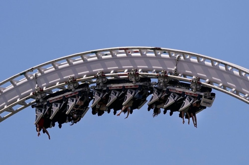 FILE - Visitors ride a roller coaster at Six Flags Magic Mountain in Valencia, Calif., April 1, 2021. (AP Photo/Jae C. Hong, File)