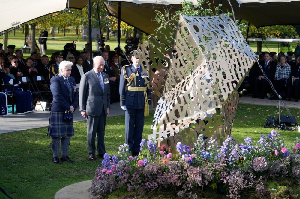 King Charles III stands during a visit to the National Memorial Arboretum in Alrewas, Staffordshire, for the dedication ceremony of the LGBT+ Armed Forces memorial, the UK's first national memorial commemorating LGBT+ people who have served and continue to serve in the military, Monday, Oct. 27, 2025. (Peter Byrne/PA via AP)