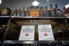 A sign is placed in front of the American whiskey section at a B.C. liquor store before top selling American made products are to be removed from shelves as a demonstration for media in Vancouver, B.C., Sunday, Feb. 2, 2025. THE CANADIAN PRESS/Ethan Cairns