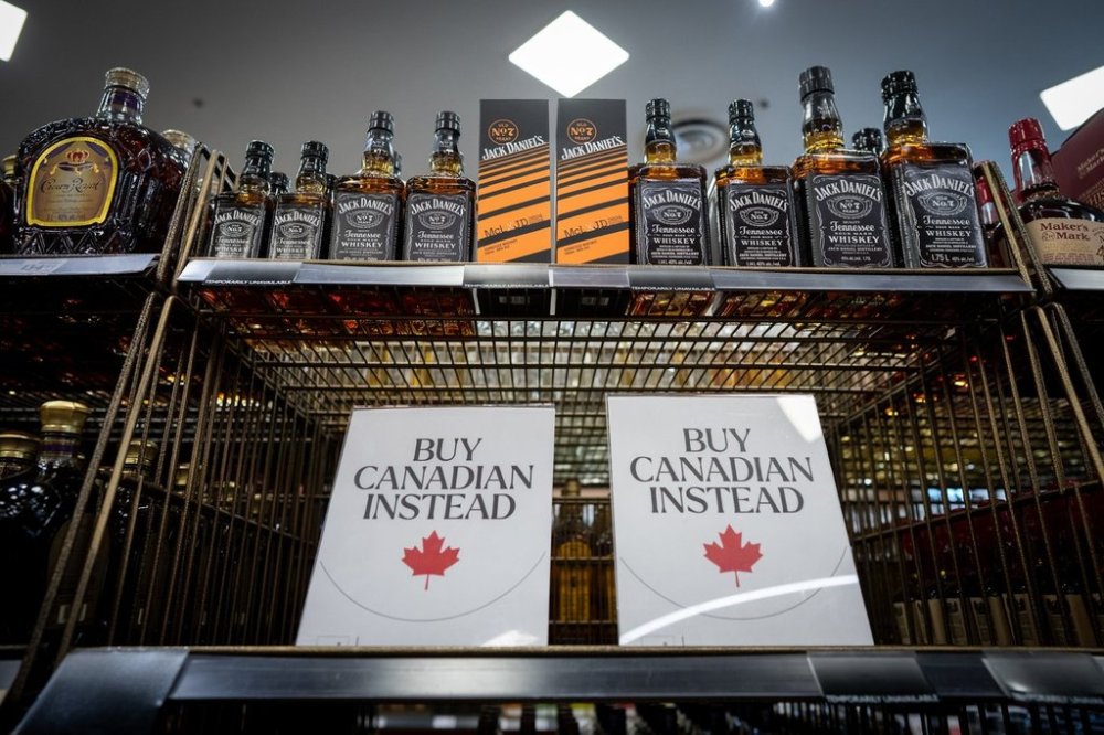 A sign is placed in front of the American whiskey section at a B.C. liquor store before top selling American made products are to be removed from shelves as a demonstration for media in Vancouver, B.C., Sunday, Feb. 2, 2025. THE CANADIAN PRESS/Ethan Cairns