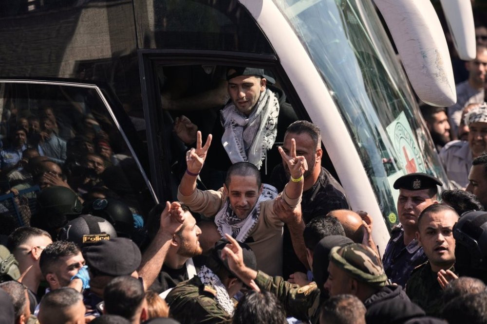 A Palestinian prisoner makes the victory sign after being released from an Israeli prison as part of a ceasefire deal between Israel and Hamas, upon his arrival in the West Bank city of Ramallah, Monday, Oct. 13, 2025. (AP Photo/Majdi Mohammed)