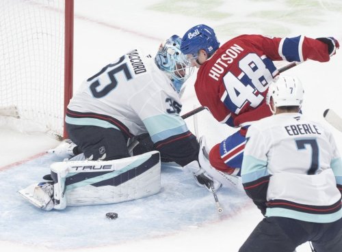 Seattle Kraken goaltender Joey Daccord (35) makes a save against Montreal Canadiens' Lane Hutson (48) during first period NHL hockey action in Montreal on Tuesday, Oct. 14, 2025. THE CANADIAN PRESS/Christinne Muschi