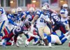 Winnipeg Blue Bombers' Brady Oliveira (20) runs with the ball while defended by Montreal Alouettes' Lorenzo Burns (20) during second half Eastern semi-final action, in Montreal on Saturday, Nov. 1, 2025. THE CANADIAN PRESS/Christopher Katsarov