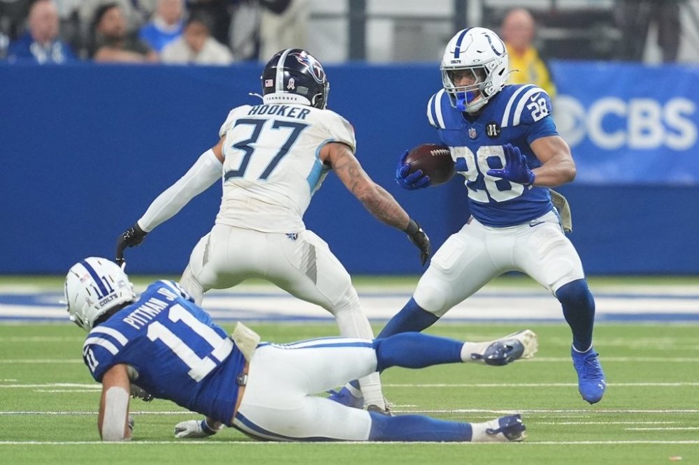 Indianapolis Colts running back Jonathan Taylor (28) runs against Tennessee Titans safety Amani Hooker (37) during the second half an NFL football game, Sunday, Oct. 26, 2025, in Indianapolis. (AP Photo/Michael Conroy)