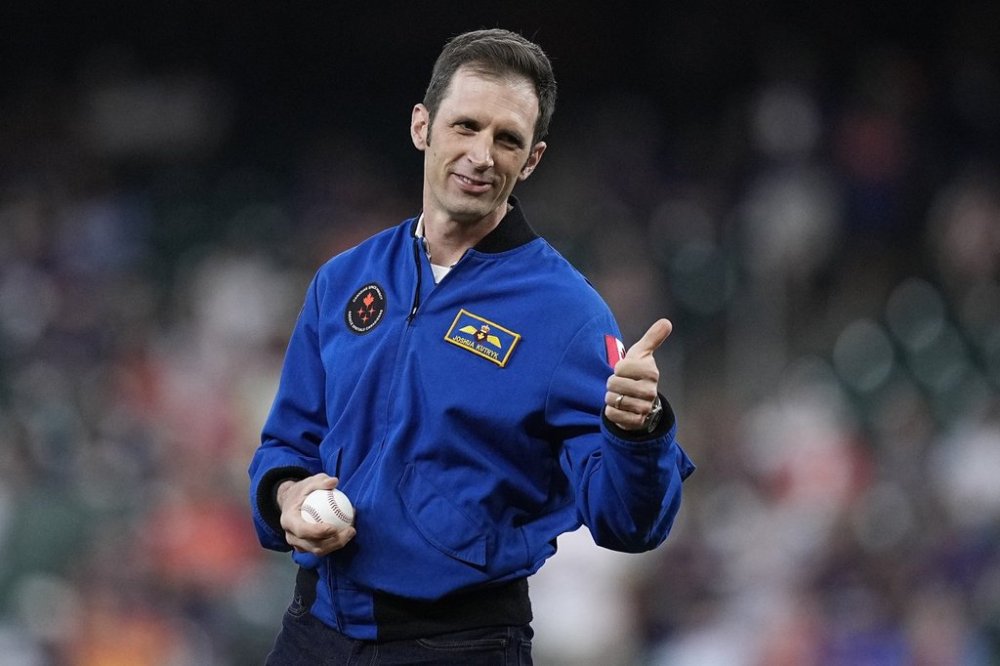 Canadian astronaut Joshua Kutryk throws out the ceremonial first pitch before a baseball game between the Houston Astros and the Toronto Blue Jays, in Houston, Monday, April 1, 2024. THE CANADIAN PRESS/AP-Kevin M. Cox