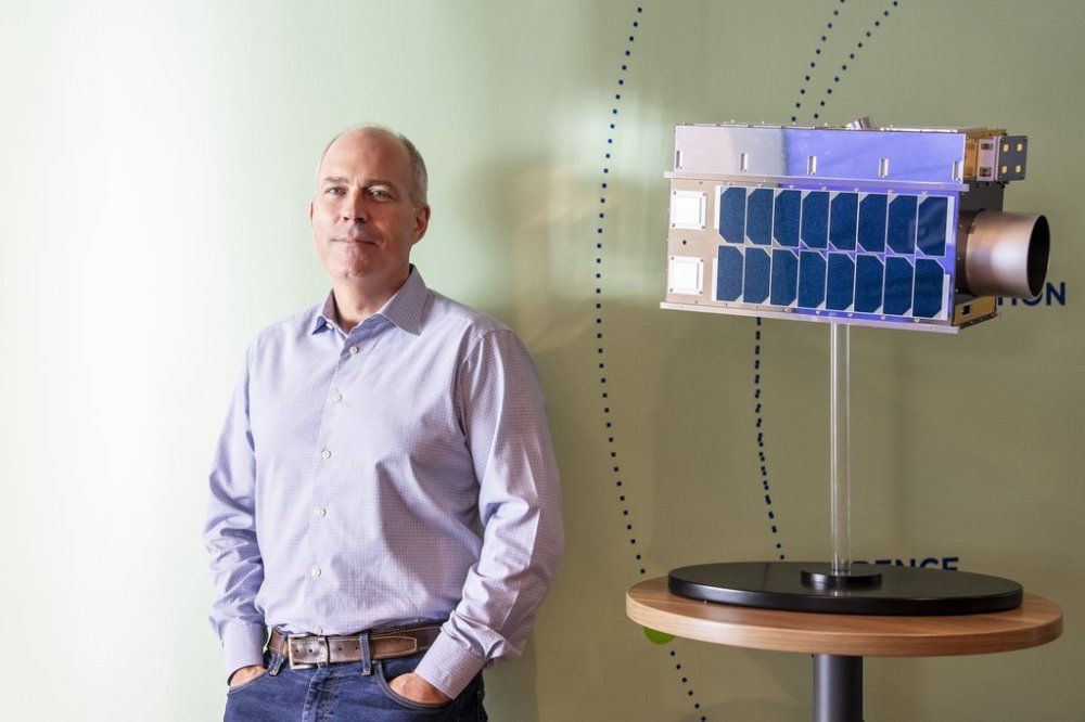 Stephane Germain, president of GHGSat Inc., poses for a photograph with a life-size model of a satellite, in their offices in Montreal on Friday, Sept. 19, 2025. THE CANADIAN PRESS/Christopher Katsarov
