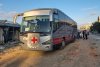Red Cross vehicles and buses stand by in Khan Younis, southern Gaza Strip, on Monday, Oct. 13, 2025, ahead of the release of Palestinian prisoners by Israel. (AP Photo/Mohammad Jahjouh)