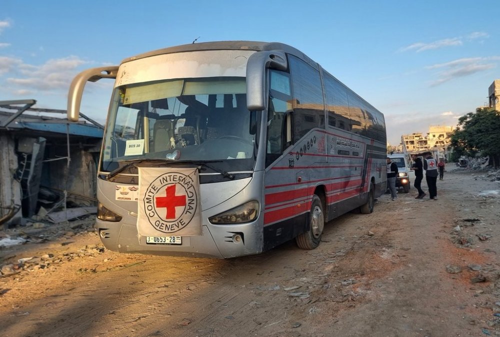 Red Cross vehicles and buses stand by in Khan Younis, southern Gaza Strip, on Monday, Oct. 13, 2025, ahead of the release of Palestinian prisoners by Israel. (AP Photo/Mohammad Jahjouh)