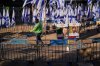 A worker cleans the ground at the plaza known as hostages square, in Tel Aviv, Israel, Tuesday, Oct. 14, 2025. (AP Photo/Francisco Seco)