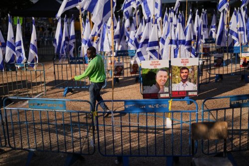 A worker cleans the ground at the plaza known as hostages square, in Tel Aviv, Israel, Tuesday, Oct. 14, 2025. (AP Photo/Francisco Seco)