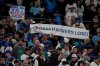Toronto Blue Jays fans hold signs during the eighth inning in Game 3 of baseball's American League Championship Series against the Seattle Mariners, Wednesday, Oct. 15, 2025, in Seattle. (AP Photo/Lindsey Wasson)