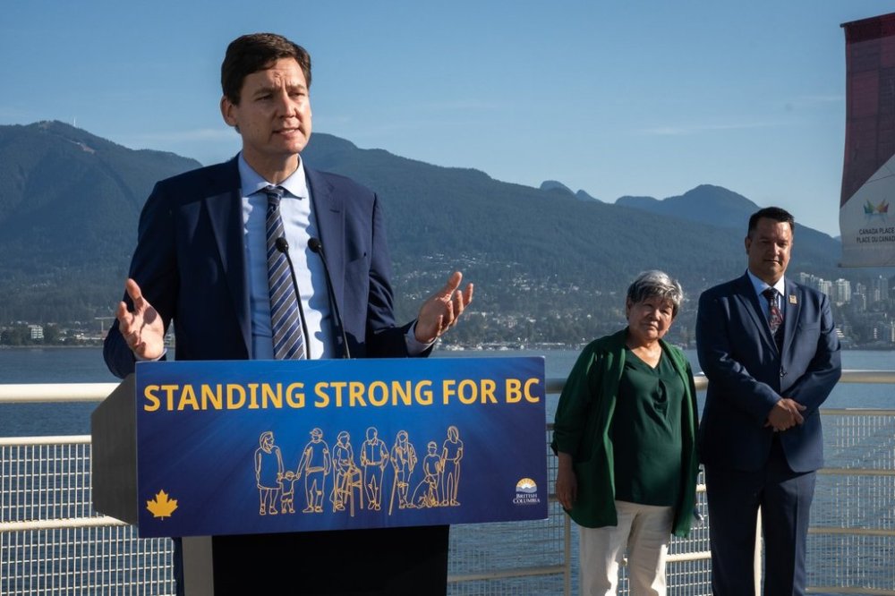 B.C. Premier David Eby speaks as Nisga'a Nation President, Eva Clayton and Nisga'a CEO, Andrew Robinson listen during a Ksi Lisims LNG announcement of an environmental assessment certificate from the Government of British Columbia in Vancouver, on Tuesday, Sept. 16, 2025. THE CANADIAN PRESS/Ethan Cairns