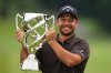 Xander Schauﬀele, of the U.S., poses for a photo with his trophy after he won the Baycurrent Classic golf tournament at the Yokohama Country Club in Yokohama, near Tokyo, Sunday, Oct. 12, 2025. (AP Photo/Hiro Komae)
