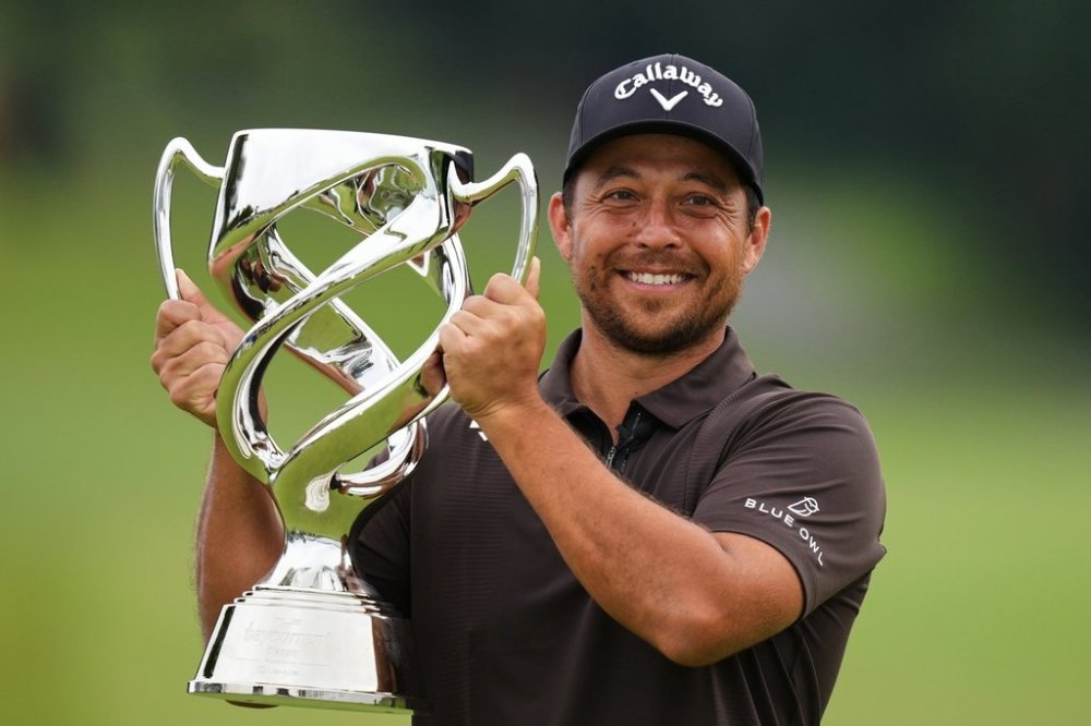 Xander Schauffele, of the U.S., poses for a photo with his trophy after he won the Baycurrent Classic golf tournament at the Yokohama Country Club in Yokohama, near Tokyo, Sunday, Oct. 12, 2025. (AP Photo/Hiro Komae)