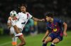 PSG's Bradley Barcola, left, challenges for the ball with Barcelona's Pau Cubarsi during the Champions League opening phase soccer match between Barcelona and Paris Saint-Germain at the Lluis Companys Olympic Stadium in Barcelona, Spain, Wednesday, Oct.1, 2025. (AP Photo/Emilio Morenatti)