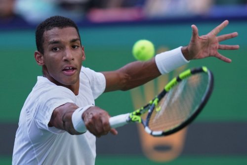 Felix Auger-Aliassime of Canada returns a backhand shot from Arthur Rinderknech of France during their men's singles quarterfinal match of the Shanghai Masters tennis tournament at Qizhong Forest Sports City Tennis Center, in Shanghai, China, Friday, Oct. 10, 2025. (AP Photo/Andy Wong)
