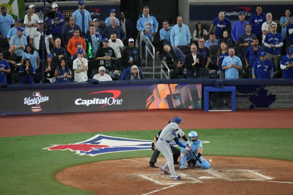 Fan John Chisholm (center stairs) watches Los Angeles Dodgers designated hitter Shohei Ohtani during eighth inning Game 6 World Series playoff MLB baseball action against the Toronto Blue Jays, in Toronto, Friday, Oct. 31, 2025. THE CANADIAN PRESS/Chris Young