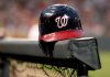 FILE - A Washington Nationals helmet sits in the dugout railing before a baseball game against the Baltimore Orioles in Baltimore, Friday, June 22, 2012. (AP Photo/Patrick Semansky, File)