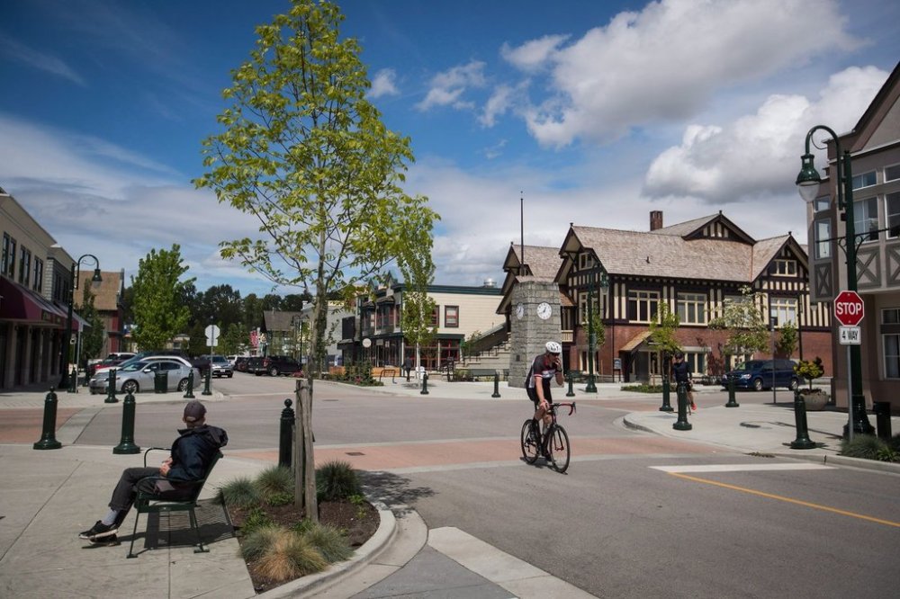 A man watches as a cyclist passes by in Ladner, B.C., on Wednesday May 9, 2018. THE CANADIAN PRESS/Darryl Dyck
