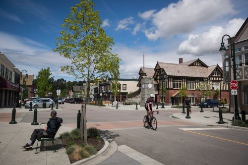 A man watches as a cyclist passes by in Ladner, B.C., on Wednesday May 9, 2018. THE CANADIAN PRESS/Darryl Dyck