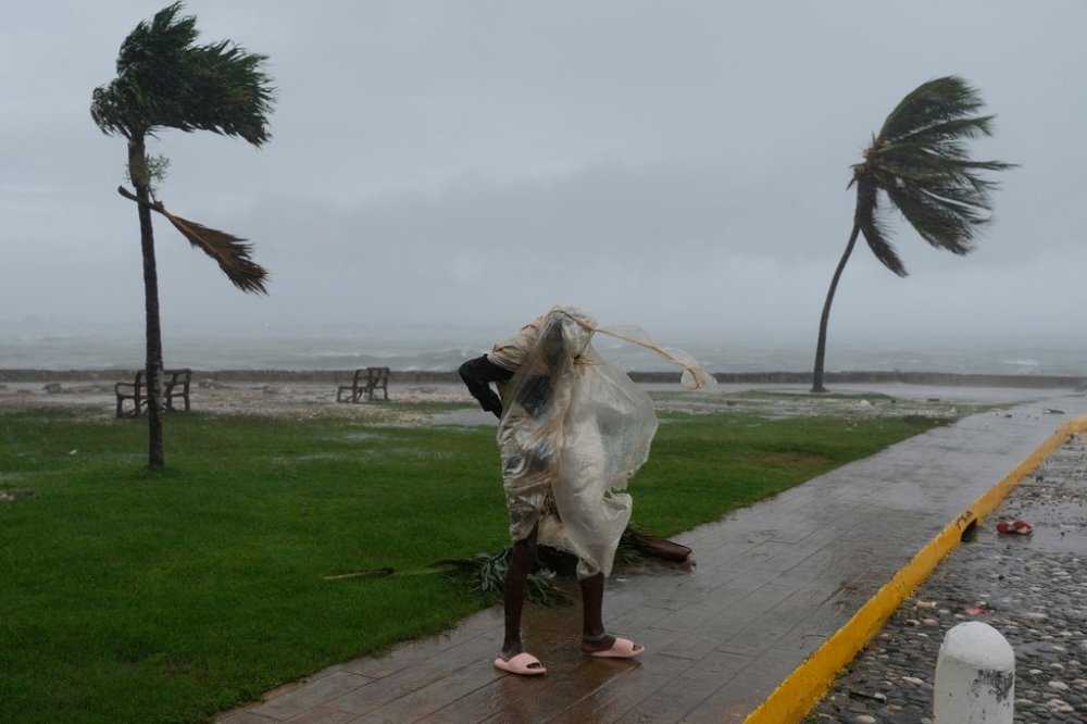A man walks in Kingston, Jamaica, as Hurricane Melissa approaches, Tuesday, Oct. 28, 2025. (AP Photo/Matias Delacroix)