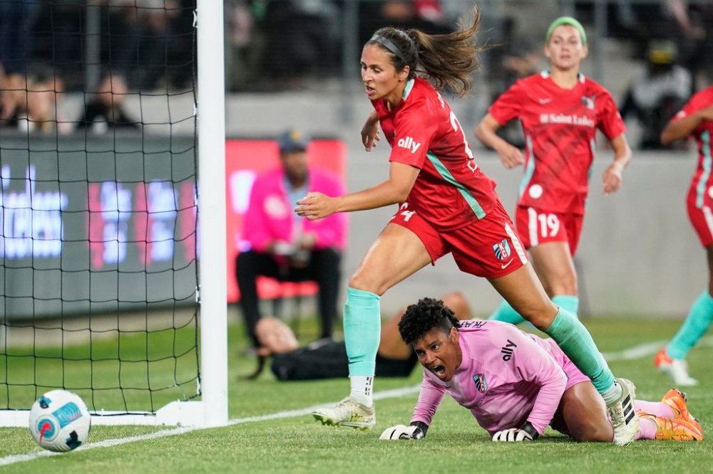 FILE - Kansas City Current goal keeper Adrianna Franch, bottom, and defender Taylor Leach (24) allow a goal by Angel City FC forward Christen Press during the second half of an NWSL soccer match in Los Angeles, May 21, 2022. (AP Photo/Ashley Landis, File)