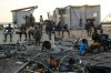 FILE - People gather among debris near a bridge in Black River, Jamaica, Oct. 30, 2025, in the aftermath of Hurricane Melissa. (AP Photo/Matias Delacroix, File)