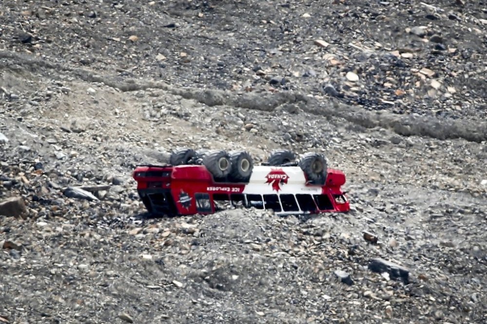 A rolled-over tour bus rests where it crashed on the Columbia Icefield near Jasper, Alta., Sunday, July 19, 2020. An inquiry into the accident that killed three people is set for Friday. THE CANADIAN PRESS/Jeff McIntosh
