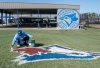 A painter touches up the Toronto Blue Jays logo on the training hill at the Spring Training facility in Dunedin, Fla. on February 21, 2024. THE CANADIAN PRESS/Frank Gunn
