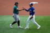 Seattle Mariners' Josh Naylor, left, greets Toronto Blue Jays' Andrés Giménez prior to Game 2 of baseball's American League Championship Series against the Toronto Blue Jays, Monday, Oct. 13, 2025, in Toronto. (AP Photo/David J. Phillip)