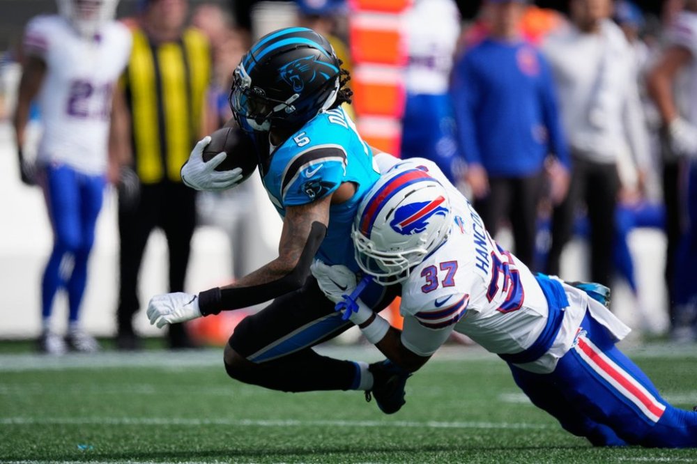 Buffalo Bills cornerback Jordan Hancock (37) tackles Carolina Panthers running back Rico Dowdle (5) during the first half an NFL football game, Sunday, Oct. 26, 2025, in Charlotte, N.C. (AP Photo/Jacob Kupferman)