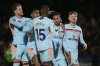 Brentford's Fabio Carvalho, second right, celebrates scoring with teammates during the English League Cup fourth round soccer match between Grimsby Town and Brentford in Grimsby, England, Tuesday Oct. 28, 2025. (Mike Egerton/PA via AP)