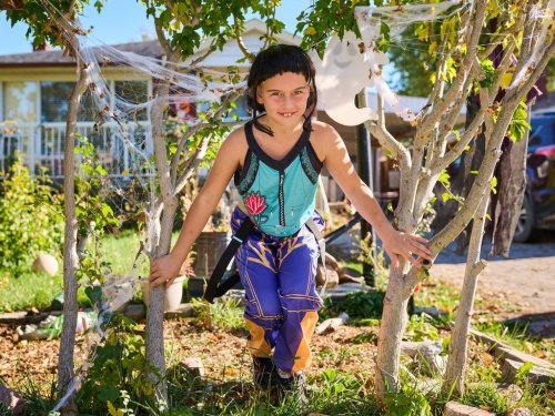 Eight-year-old Betsy Schruder poses for a portrait in her Halloween costume as Zoey from Netflix's 