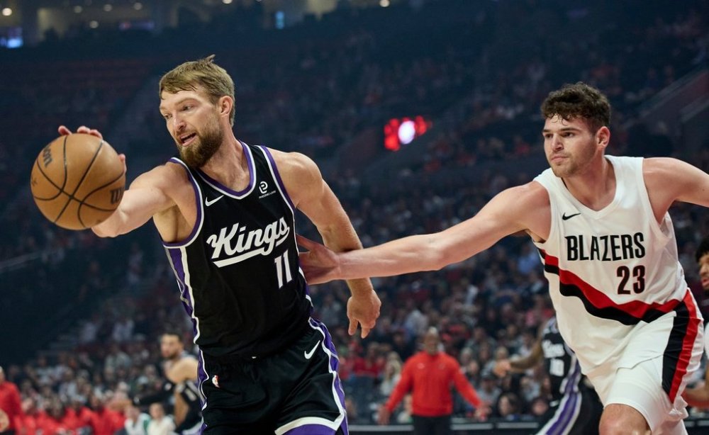 Sacramento Kings center Domantas Sabonis, left, collects a rebound in front of Portland Trail Blazers center Donovan Clingan, right, during the first half of an NBA basketball preseason game in Portland, Ore., Friday, Oct. 10, 2025. (AP Photo/Craig Mitchelldyer)