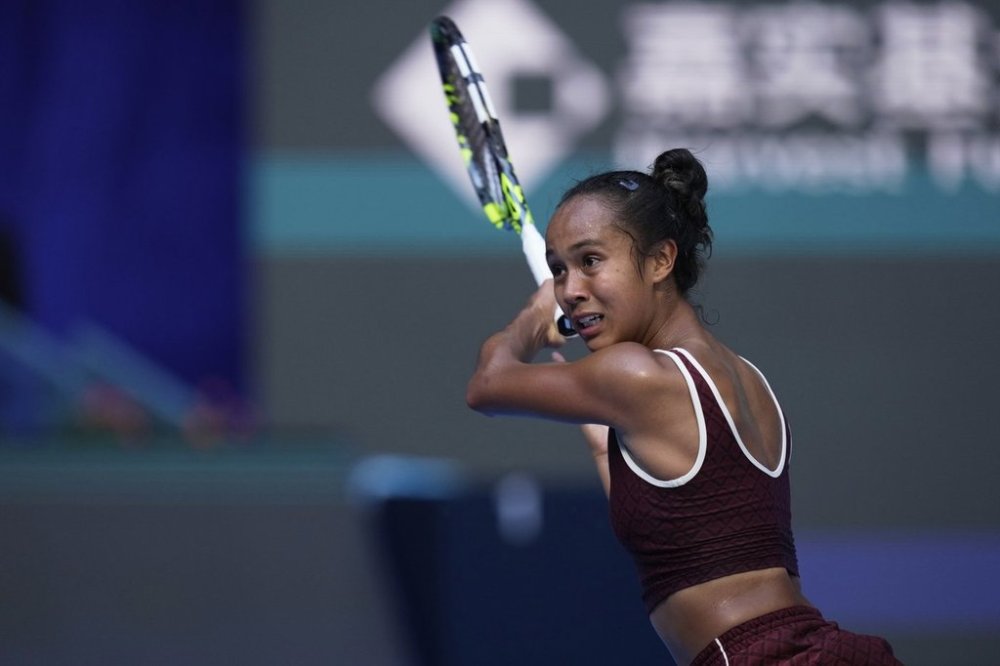Leylah Fernandez of Canada plays a backhand return to Coco Gauff of the United States during a women's singles match of the China Open tennis tournament, at the National Tennis Center, in Beijing, China, Sunday, Sept. 28, 2025. (AP Photo/Mahesh Kumar A.)