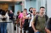 Travelers wait in line for screening at Louis Armstrong New Orleans International Airport in Kenner, La., Wednesday, Oct. 15, 2025. (AP Photo/Gerald Herbert)