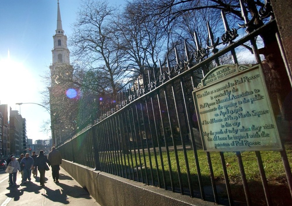 FILE - A marker signifying the burial place of Paul Revere appears on the fence at the Old Granary Burying Ground in Boston on Dec. 31, 2003. (AP Photo/Chitose Suzuki, File)