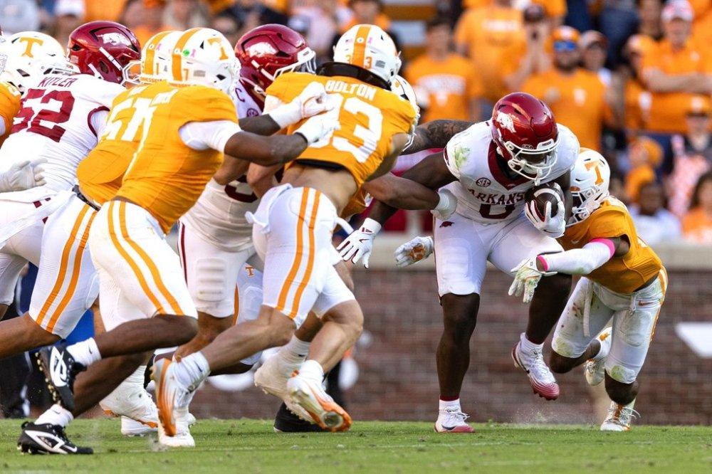 Arkansas running back Braylen Russell (0) runs for yardage as he's hit by a Tennessee defender during the first half of an NCAA college football game Saturday, Oct. 11, 2025, in Knoxville, Tenn. (AP Photo/Wade Payne)