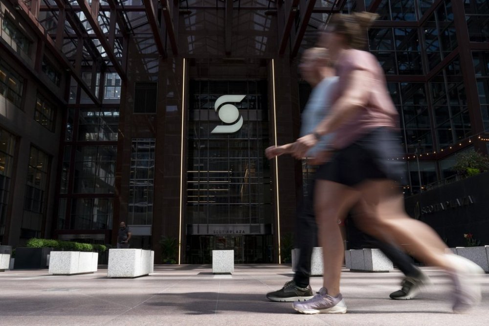 People make their way past a Scotiabank building in the Financial District of Toronto, Monday, Aug. 14, 2023. THE CANADIAN PRESS/Spencer Colby