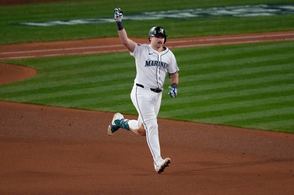 Seattle Mariners' Cal Raleigh celebrates his solo home run during the eighth inning in Game 5 of baseball's American League Championship Series against the Toronto Blue Jays, Friday, Oct. 17, 2025, in Seattle. (AP Photo/David J. Phillip)