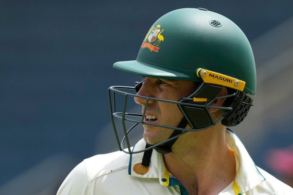 FILE - Australia's captain Pat Cummins walks of the field, bowled by West Indies' Alzarri Joseph, on day three of the third Test cricket match at Sabina Park in Kingston, Jamaica, July 14, 2025. (AP Photo/Ricardo Mazalan, File)