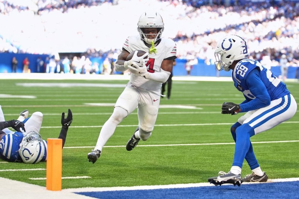 Arizona Cardinals' Greg Dortch runs after a catch for a touchdown during the second half of an NFL football game against the Indianapolis Colts Sunday, Oct. 12, 2025, in Indianapolis. (AP Photo/Michael Conroy)